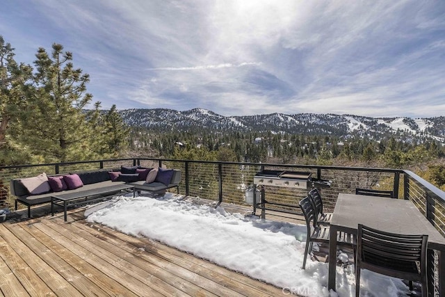 wooden terrace with a grill, a mountain view, outdoor lounge area, and a wooded view