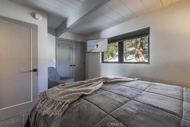 bedroom with wood ceiling, a closet, and beam ceiling