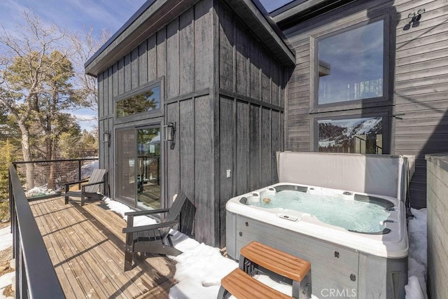 wooden deck featuring a hot tub