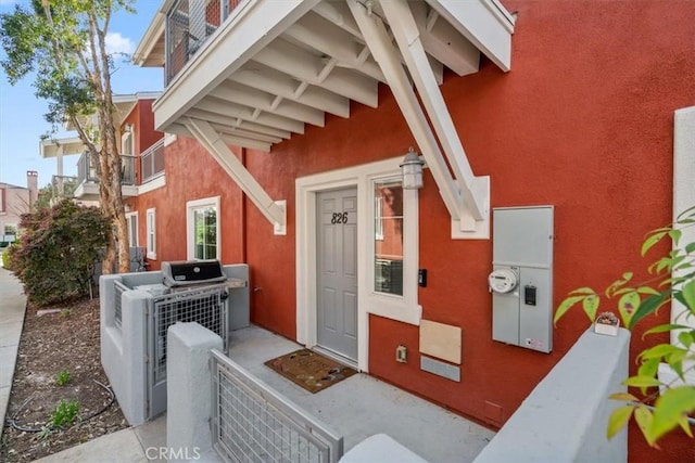 doorway to property with stucco siding