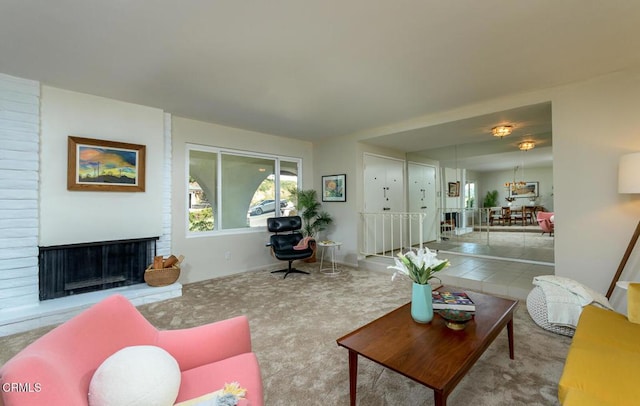 living room featuring a brick fireplace and carpet flooring