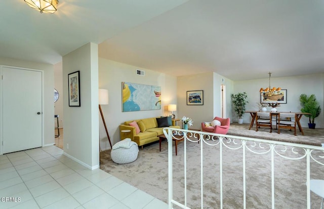 living area with visible vents, baseboards, and light tile patterned floors