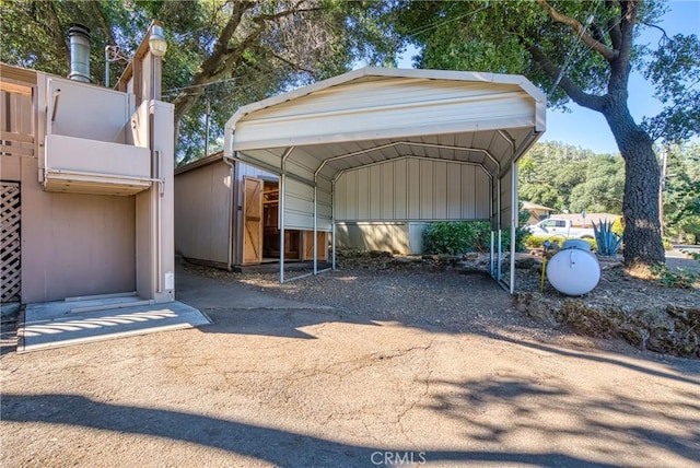 view of parking / parking lot featuring driveway and a detached carport