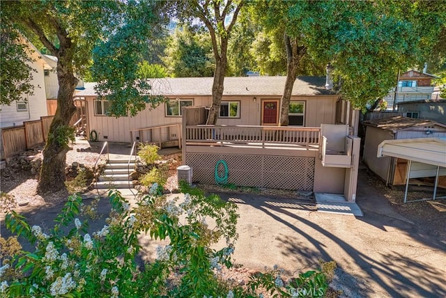 view of front facade with crawl space, fence, a deck, and stairs