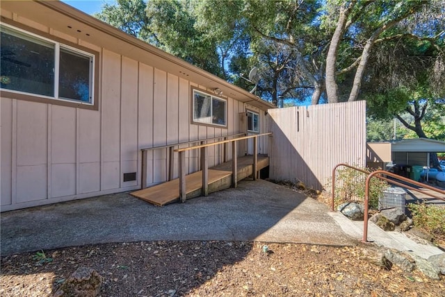 exterior space with board and batten siding and fence