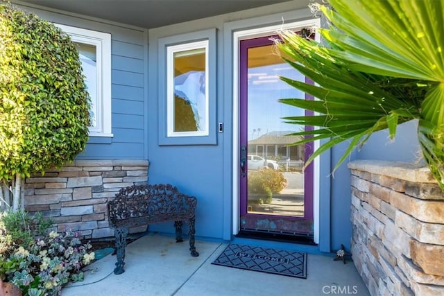 entrance to property with stone siding