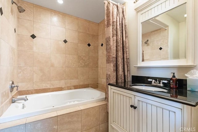bathroom featuring tiled shower / bath combo and vanity