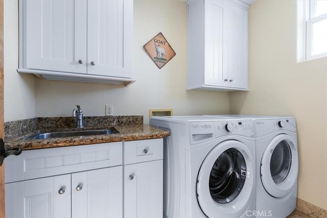 laundry area with a sink, cabinet space, and washer and dryer