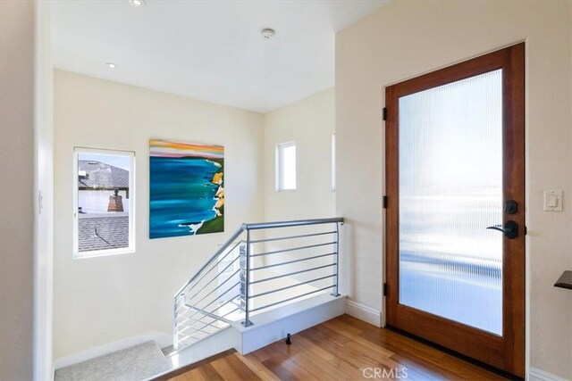 entryway with wood finished floors and baseboards