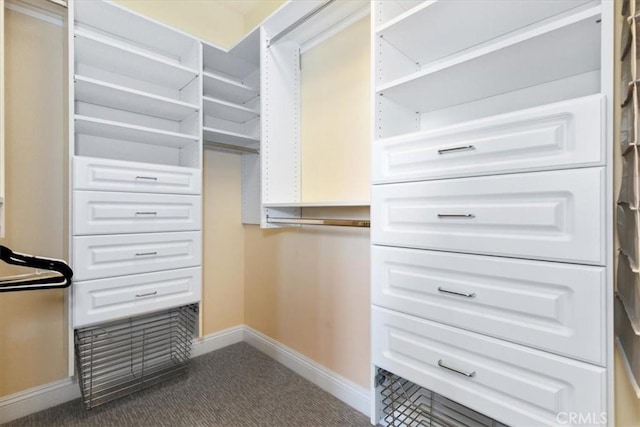 spacious closet featuring dark carpet