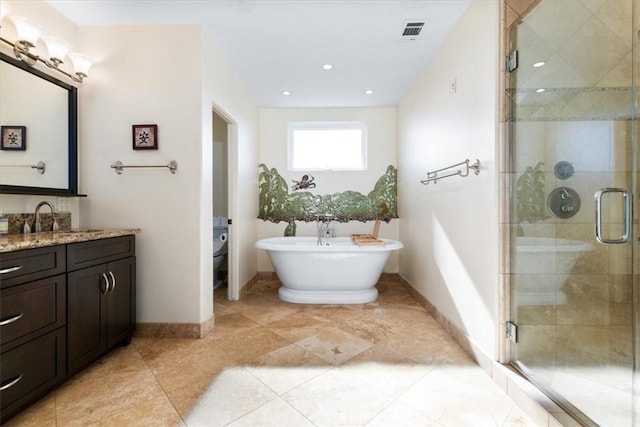 bathroom featuring vanity, a shower stall, visible vents, and baseboards