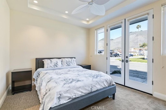 carpeted bedroom with recessed lighting, a raised ceiling, a ceiling fan, access to outside, and baseboards