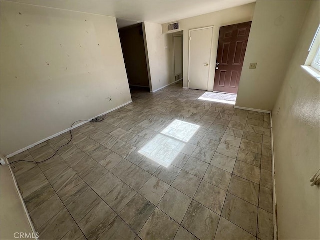 unfurnished bedroom featuring visible vents and baseboards