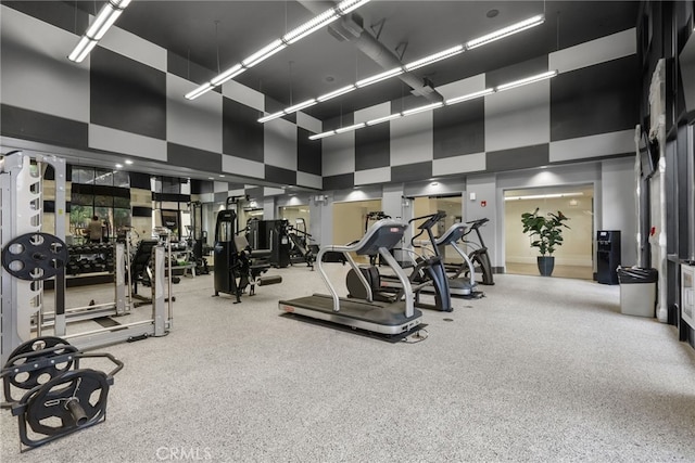 workout area with a towering ceiling