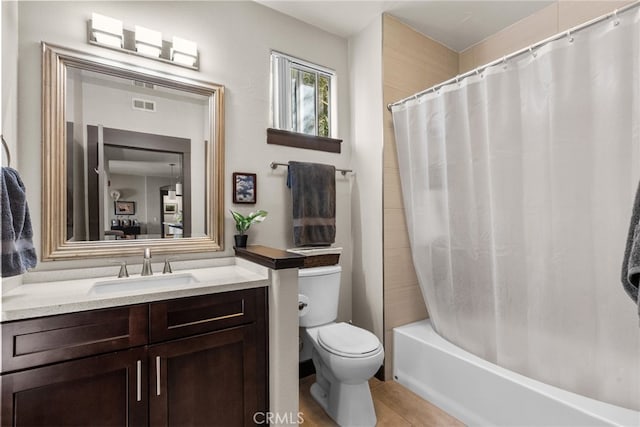 full bathroom featuring toilet, shower / bath combination with curtain, vanity, and visible vents