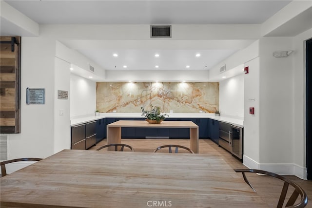 kitchen with tasteful backsplash, light countertops, and visible vents