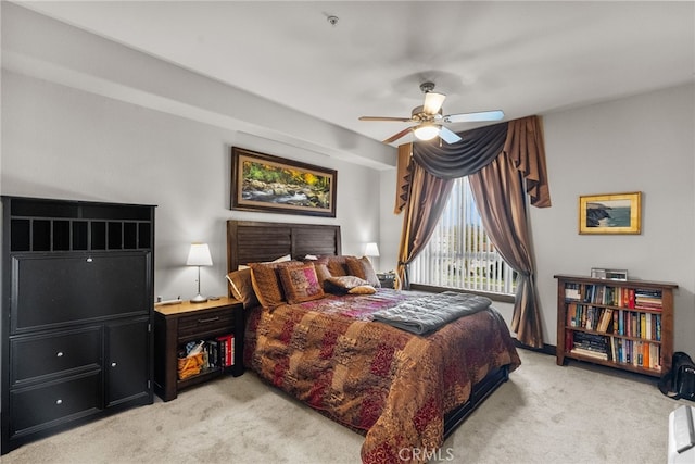 bedroom featuring light carpet, access to outside, and a ceiling fan