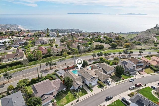 drone / aerial view with a residential view and a water view