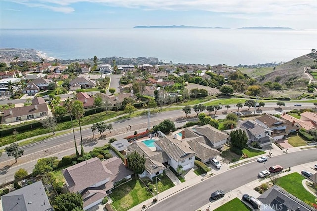 drone / aerial view with a water view and a residential view