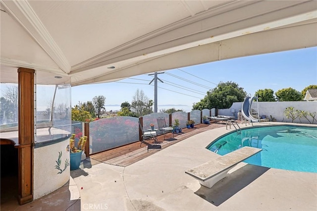 5726 Sunmist Dr, Rancho Palos Verdes, CA 90275 - view of swimming pool with a water slide, a patio area, a diving board, and fence
