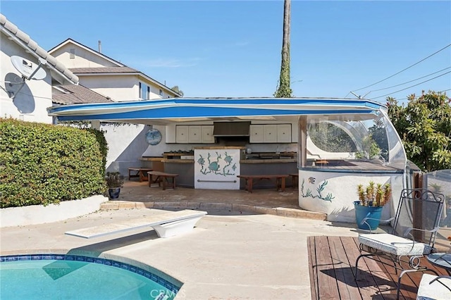 5726 Sunmist Dr, Rancho Palos Verdes, CA 90275 - outdoor pool with a patio, an outdoor kitchen, and a diving board