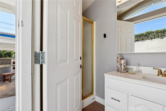 5726 Sunmist Dr, Rancho Palos Verdes, CA 90275 - full bathroom featuring healthy amount of natural light, a stall shower, vanity, and wood finished floors