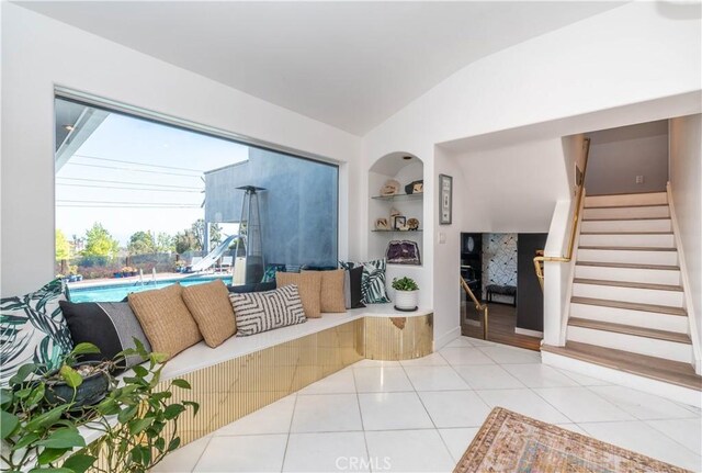 5726 Sunmist Dr, Rancho Palos Verdes, CA 90275 - living room with lofted ceiling, stairway, built in features, and light tile patterned floors