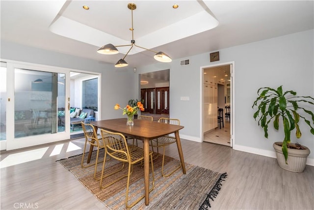 5726 Sunmist Dr, Rancho Palos Verdes, CA 90275 - dining area with a tray ceiling, wood finished floors, and baseboards