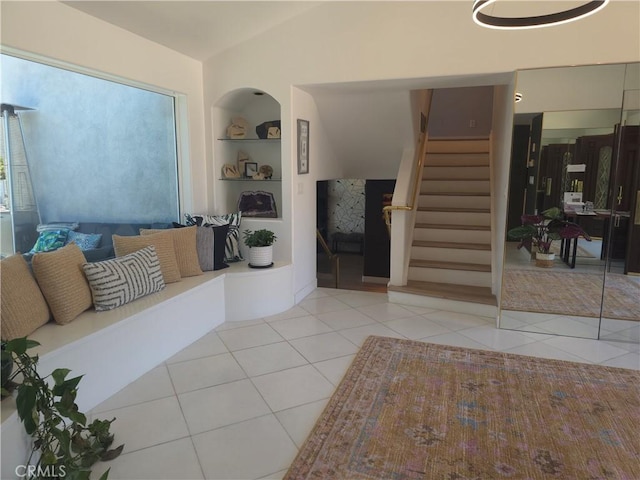 5726 Sunmist Dr, Rancho Palos Verdes, CA 90275 - tiled living room featuring built in shelves, stairway, and vaulted ceiling