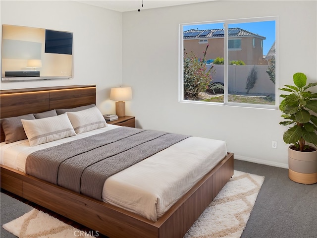 bedroom with carpet flooring and baseboards