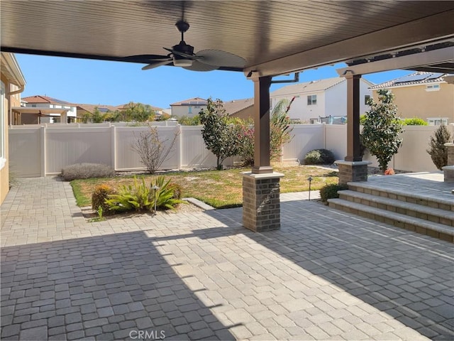 view of patio featuring a fenced backyard and a ceiling fan