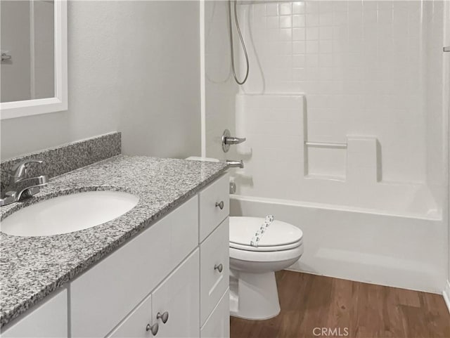 full bath featuring tub / shower combination, vanity, toilet, and wood finished floors