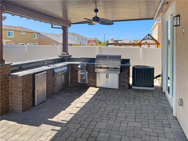 view of patio featuring a fenced backyard, central AC, area for grilling, a ceiling fan, and grilling area