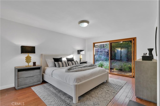 bedroom featuring baseboards and light wood-style floors