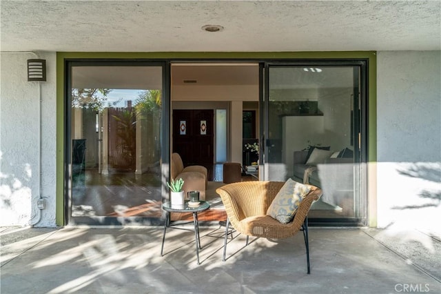 view of exterior entry featuring stucco siding