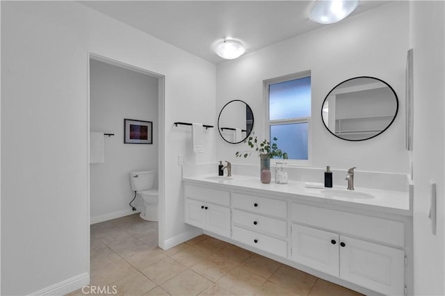 full bath featuring tile patterned floors, a sink, toilet, and double vanity