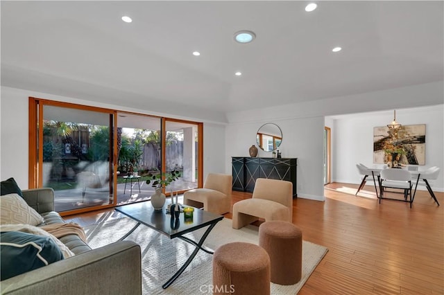 living room with baseboards, light wood finished floors, and recessed lighting