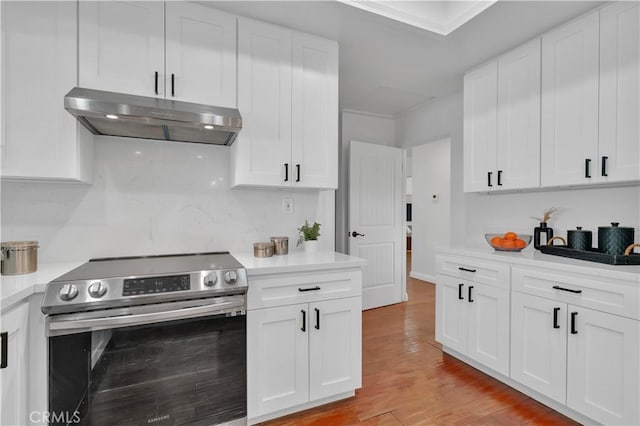 kitchen featuring stainless steel electric range oven, light countertops, white cabinetry, and under cabinet range hood