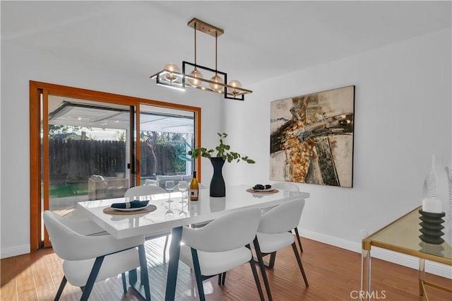 dining area featuring baseboards and wood finished floors