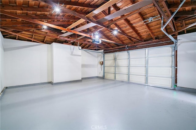 garage featuring baseboards and a garage door opener