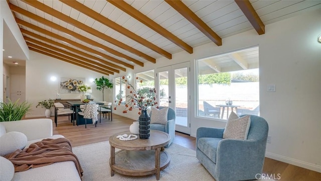 living room featuring vaulted ceiling with beams, french doors, light wood finished floors, and baseboards