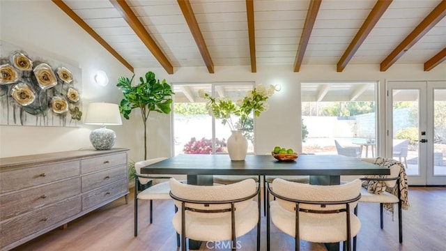 dining room with vaulted ceiling with beams, wood finished floors, and french doors