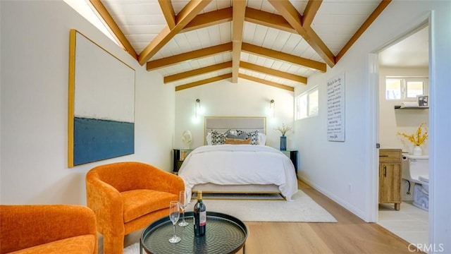 bedroom with vaulted ceiling with beams, wood finished floors, and baseboards