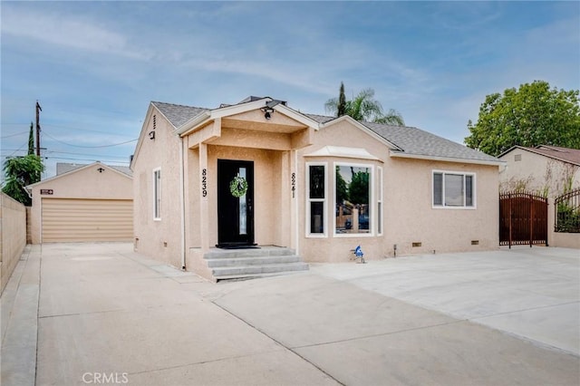 view of front of property with an outbuilding, stucco siding, crawl space, a gate, and a garage