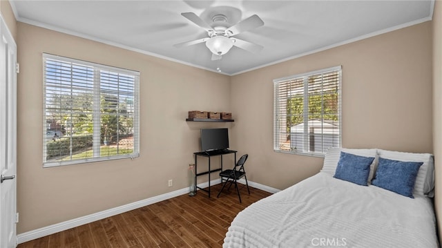 bedroom featuring multiple windows, baseboards, dark wood-type flooring, and ornamental molding