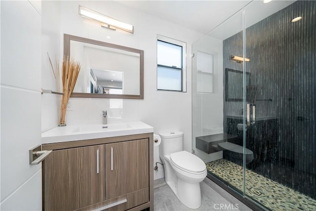 bathroom featuring a shower stall, toilet, and vanity