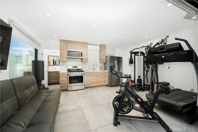 workout area featuring light tile patterned floors, a sink, and recessed lighting