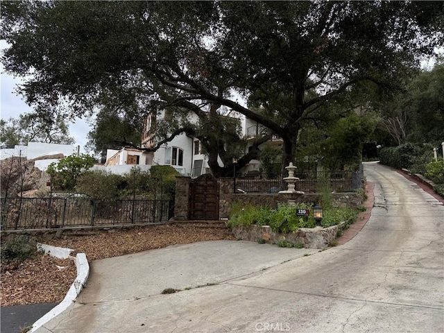 exterior space with a fenced front yard and a gate