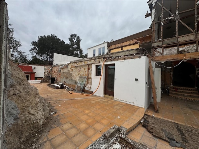 back of property featuring a patio and stucco siding