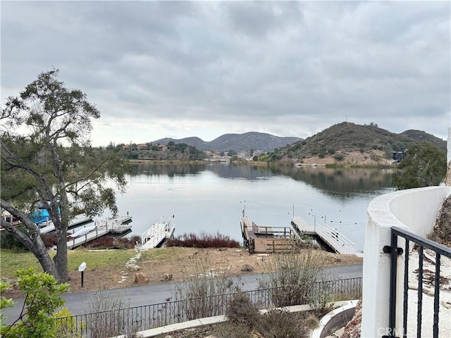 property view of water with a mountain view and a floating dock